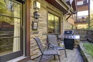 a patio with two chairs and a grill on a house at EDM 1520-2/Natural beauty in Mont-Tremblant