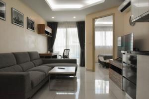 a living room with a couch and a television at Water Park Condominium in Pattaya South