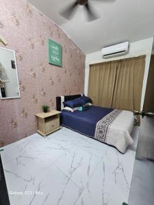 a bedroom with a bed and a ceiling fan at Maisarah Homestay Melaka, Islamic Home in Melaka in Melaka