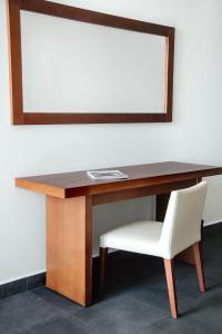 a wooden desk with a chair and a mirror at Avala Resort & Villas in Budva