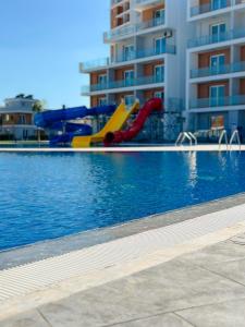 a pool with a slide and a water park at 1 Bedroom Design Apartment in Iskele North Cyprus in Iskele