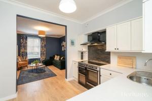 an open kitchen and living room with a couch at Barclay House, Stonehaven Seaside Home in Stonehaven