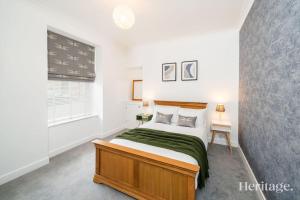 a bedroom with a large bed and a window at Barclay House, Stonehaven Seaside Home in Stonehaven