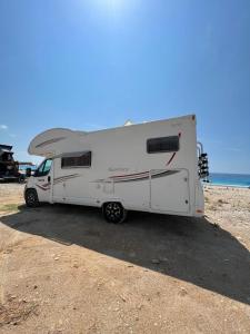 a white camper parked on the beach at Camper Rent motorhome Albania in Tirana