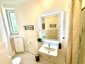 a white bathroom with a sink and a mirror at Scandinavian Relax, Netflix, central, keyless in Essen +23 photos