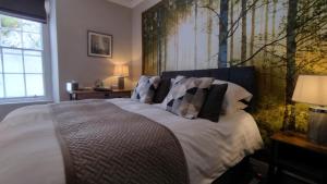 a bedroom with a bed with white sheets and pillows at Plas Tan y Graig B&B Guest House Beddgelert in Beddgelert