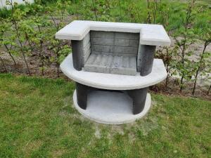 a stone bench sitting in the grass at Nieuw - Luxe Blokhut Chalet in bosrijke omgeving in Anloo +53 photos