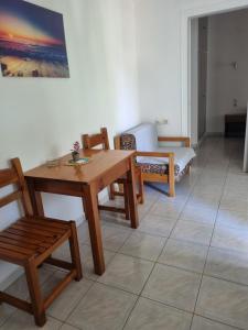a living room with a table and chairs and a couch at Sun Ray Sivota 8 in Syvota +24 photos