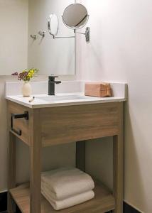 a bathroom vanity with a sink and a mirror at The Monarch in Scottsdale