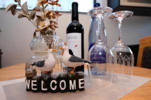 three seagulls sitting on a table with wine glasses at Ferienwohnung-Claudia in Schwerin in Schwerin