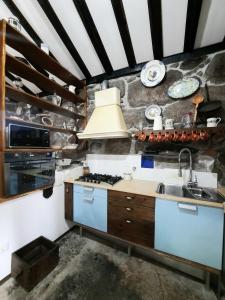 a kitchen with a sink and a stove at Casa do Tarrão 