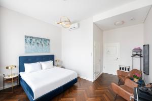 a bedroom with a bed and a couch at GRAND CROWN in Vilnius