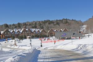 モントランブランにあるTremblant Prestige - Étoile 1510-23のロッジ前の雪に覆われたスキー場 +20枚の写真