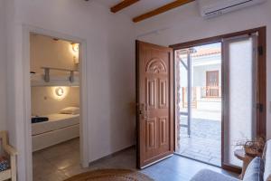 a room with a door leading to a bedroom at Eressian Lodgings - Skala Eressos in Skala Eresou +148 photos