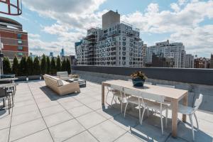 a patio with a table and chairs on a roof at East Village 1br w doorman wd nr Union Square NYC-1153 in New York