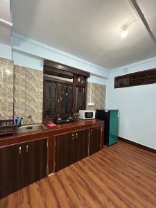 a kitchen with a sink and a counter top at Bluebird'snest in Gangtok