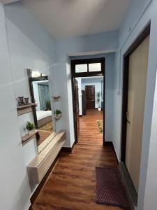 a hallway with a door and a mirror on a wall at Bluebird'snest in Gangtok