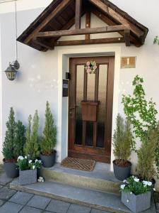 a front door of a house with potted plants at Penzion Sport in Gaming