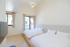 Ένα ή περισσότερα κρεβάτια σε δωμάτιο στο Vision旺民宿