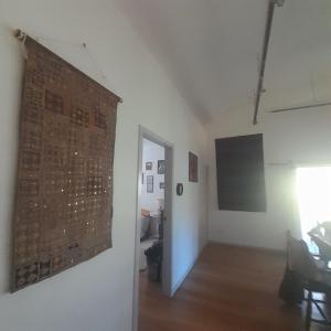a room with a wall with a picture on the wall at Bitolovo The Blue House in Nimbin