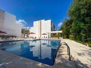 Πισίνα στο ή κοντά στο 2BR Condo in Paradise Resort at Riviera Maya