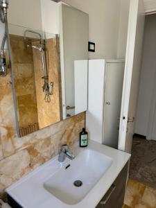 a bathroom with a sink and a shower at Micheli Luxury Flat in Rome