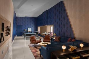 a living room with blue walls and a blue couch at Financial District 1br w WD gym elevator NYC-1370 in New York