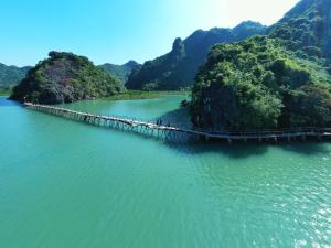 a bridge in the middle of a body of water at Tran Chau Garden Home in Cat Ba