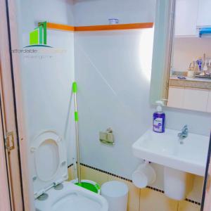 a small bathroom with a toilet and a sink at SMDC Green 2 Staycation in Dasma in Dasmariñas