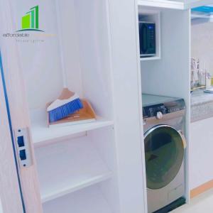 a kitchen with a washer and a washing machine at SMDC Green 2 Staycation in Dasma in Dasmariñas