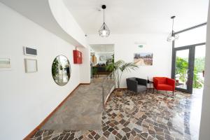 a hallway with a living room with a red chair at Hotel Auditorium in Bari