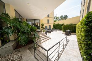 a courtyard with chairs and plants in a building at Hotel Auditorium in Bari