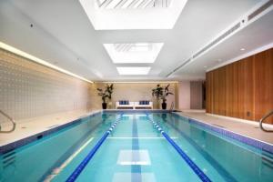 a large swimming pool in a building at Blueground Hells Kitchen gym elev nr museum NYC-1434 in New York