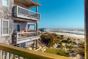 a house with a balcony and a beach at Tressa Terrace in Avon
