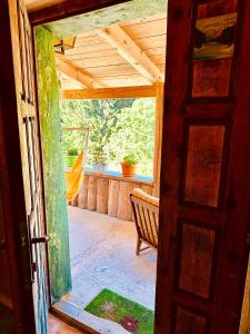 an open door to a porch with a bench at Mountain story apartment in Žabljak