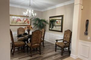 a dining room with a table and chairs at Harry Potter-Themed, Lake View, Spacious Condo Near Universal with Extra Amenities in Orlando +67 photos