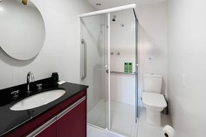a bathroom with a shower and a sink and a toilet at Zainalofts7 Pinheiros - Z Pinheiros 107 in Sao Paulo +21 photos