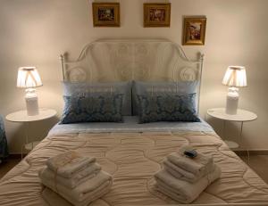 a bedroom with a bed with towels on it at Villa Biniritta in Villaggio San Leonardo