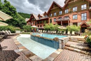 a resort with a swimming pool in front of a building at EDM 1520-2/Natural beauty in Mont-Tremblant