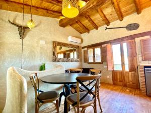 a dining room with a table and chairs at El Kubo in Olba +18 photos