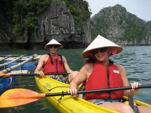 two people in a yellow kayak in the water at Tran Chau Garden Home in Cat Ba