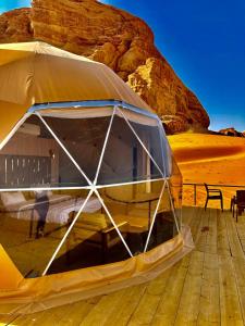 a tent on a deck in the desert at Hasan Zawaideh Camp in Wadi Rum