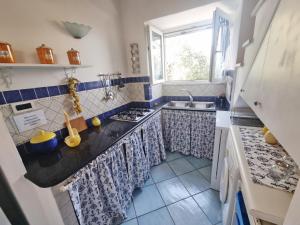 a small kitchen with a sink and a window at Maridea - Sottovento in Ponza +2 photos
