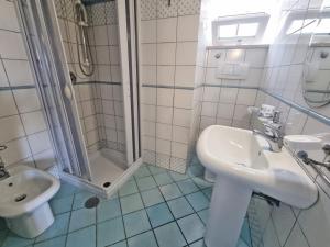 a bathroom with a sink and a shower at Maridea - Sottovento in Ponza