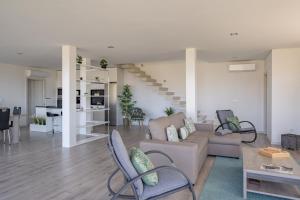 a living room with a couch and a table at Feel Discovery Alvim's Douro in Folgosa +25 photos