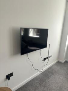 a flat screen tv hanging on a wall at New Stunning 2-Bedroom Apartment - Sleeps 4 in Bolton