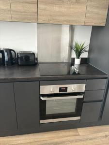 a kitchen with a counter top with a stove at New Stunning 2-Bedroom Apartment - Sleeps 4 in Bolton