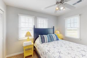 a bedroom with a bed and a ceiling fan at Striper #20A-CAC in Buxton +22 photos