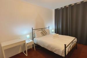 una camera da letto con un letto e una scrivania con una lampada di Quiet 2BR Apartment with Garden views in Griffith - Hosted by CanStay a Kingston  Altre 11 foto