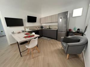 a kitchen with a table and a couch and a chair at Casa AnnaBella in Trapani